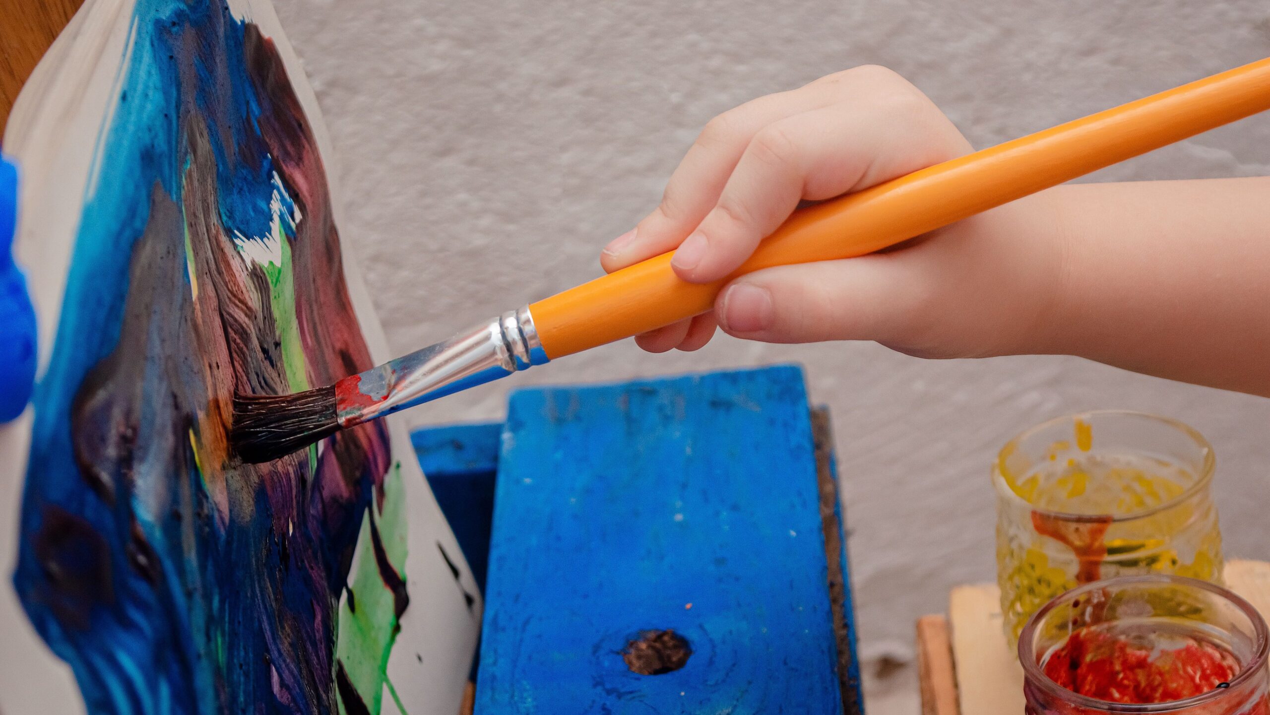 kids learning colors through paint mixing activity